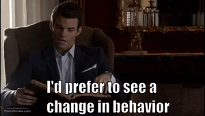 A Man In A Suit Is Sitting In A Chair Reading A Book And Says I 'D Prefer To See A Change GIF