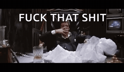 A Man In A Suit Is Sitting In A Chair Smoking A Cigarette And Drinking Whiskey . GIF