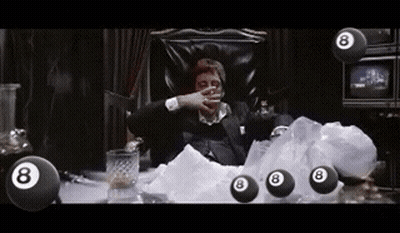 A Man In A Suit Is Sitting In A Chair Surrounded By Pool Balls . GIF