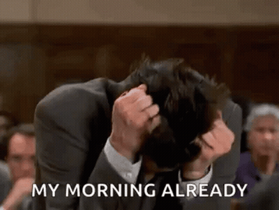 A Man In A Suit Is Sitting In A Courtroom With His Head In His Hands And Says `` My Morning Already '' . GIF