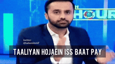 A Man In A Suit Is Sitting In Front Of A Sign That Says " Hour " GIF