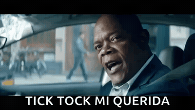 A Man In A Suit Is Sitting In The Driver 'S Seat Of A Car And Yelling . GIF