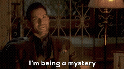 A Man In A Suit Is Smiling And Saying I 'M Being A Mystery GIF
