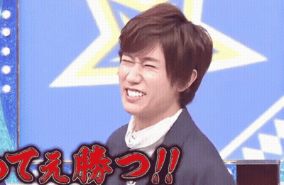A Man In A Suit Is Smiling In Front Of A Blue Background With Chinese Writing On It . GIF