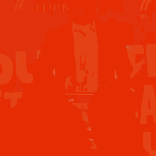 A Man In A Suit Is Speaking Into A Microphone In Front Of A Sign That Says ' Turn Point ' GIF