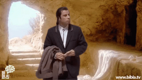 A Man In A Suit Is Standing In A Cave With The Website Www.bibla.tv On The Bottom GIF