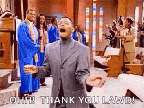 A Man In A Suit Is Standing In A Church With His Arms Outstretched And A Group Of People Behind Him . GIF