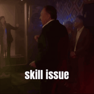 A Man In A Suit Is Standing In A Dark Room With The Words Skill Issue Written Above Him GIF
