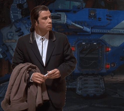 A Man In A Suit Is Standing In Front Of A Blue Tank That Says ' Armour ' On It GIF
