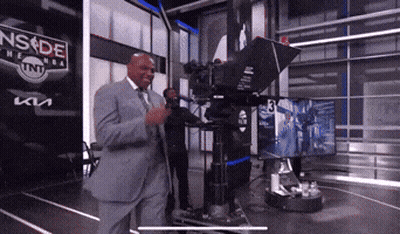 A Man In A Suit Is Standing In Front Of A Camera With A Sign That Says Nsde On It GIF