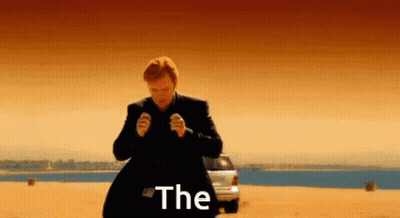 A Man In A Suit Is Standing In Front Of A Car With The Word The Written On The Screen GIF