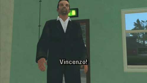 A Man In A Suit Is Standing In Front Of A Door And Says " Vincenzo " GIF