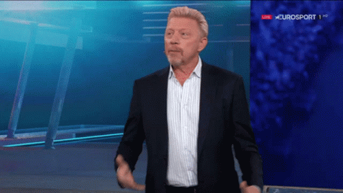 A Man In A Suit Is Standing In Front Of A Eurosport Sign GIF