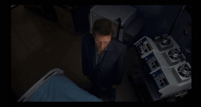 A Man In A Suit Is Standing In Front Of A Machine That Says ' A ' On It GIF