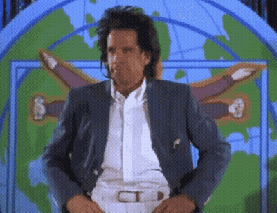 A Man In A Suit Is Standing In Front Of A Map Of The World GIF