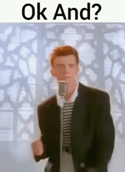 A Man In A Suit Is Standing In Front Of A Microphone And Singing . GIF