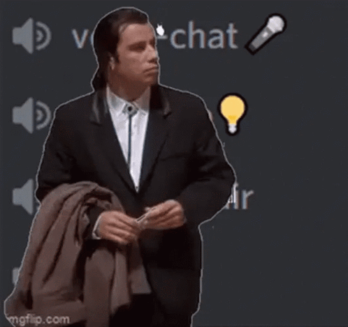A Man In A Suit Is Standing In Front Of A Microphone With A Light Bulb . GIF