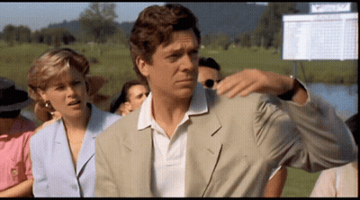 A Man In A Suit Is Standing In Front Of A Scoreboard That Says ' Masters ' GIF