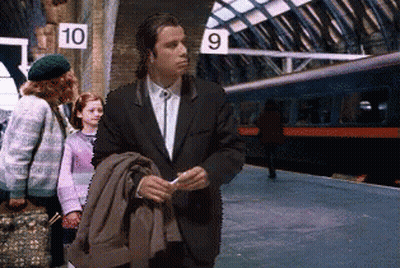 A Man In A Suit Is Standing In Front Of A Sign That Says 10 GIF