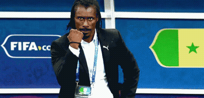 A Man In A Suit Is Standing In Front Of A Sign That Says Fifa GIF