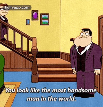 A Man In A Suit Is Standing In Front Of A Staircase And Says You Look Like The Most Handsome Man In The World GIF