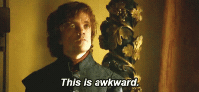 A Man In A Suit Is Standing In Front Of A Statue And Says `` This Is Awkward '' . GIF