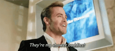 A Man In A Suit Is Standing In Front Of A Television And Says They 'Re My Shower Buddies ! GIF