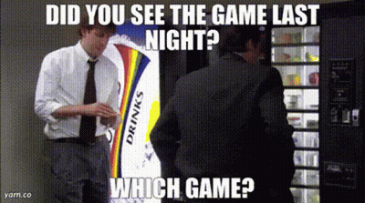 A Man In A Suit Is Standing In Front Of A Vending Machine That Says Drinks On It GIF