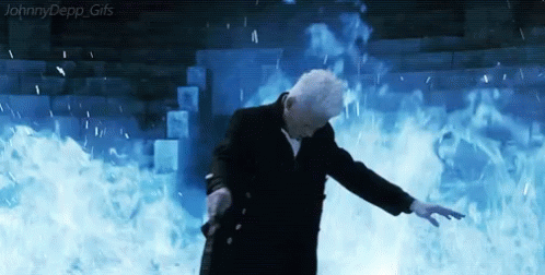 A Man In A Suit Is Standing In Front Of A Wall Of Fire And Water . GIF