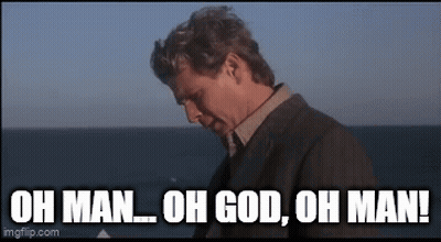 A Man In A Suit Is Standing In Front Of The Ocean And Says `` Oh Man Oh God Oh Man '' . GIF