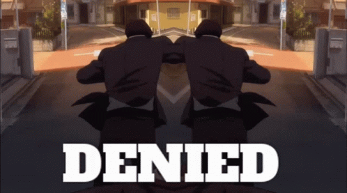 A Man In A Suit Is Standing In Front Of The Word Denied GIF