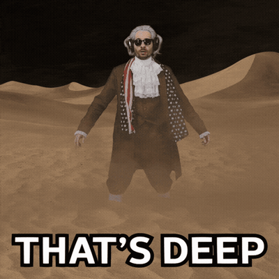 A Man In A Suit Is Standing In The Sand With The Words That 'S Deep Written Below Him GIF
