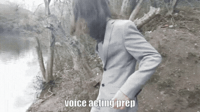 A Man In A Suit Is Standing Next To A Body Of Water And The Words Voice Acting Prep Are Above Him GIF