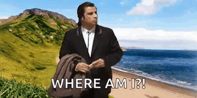 A Man In A Suit Is Standing On A Beach With The Words Where Am I ? Written Below Him GIF