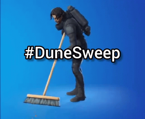 A Man In A Suit Is Sweeping The Floor With A Broom And The Words #Dunesweep Behind Him GIF