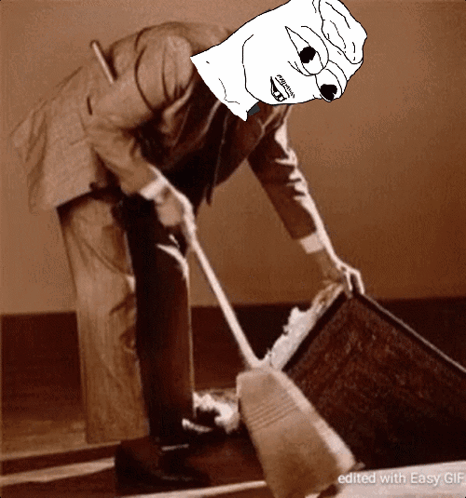 A Man In A Suit Is Sweeping The Floor With A Cartoon Face On His Face GIF