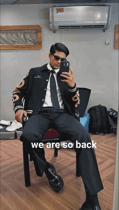 A Man In A Suit Is Taking A Picture Of Himself With The Words We Are So Back Below Him GIF