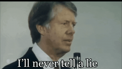 A Man In A Suit Is Talking Into A Microphone And Saying `` I 'Ll Never Tell A Lie '' . GIF