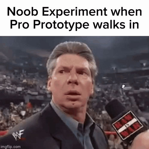 A Man In A Suit Is Talking Into A Microphone At A Wrestling Match . GIF