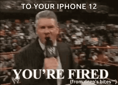 A Man In A Suit Is Talking Into A Microphone In A Wrestling Ring . GIF