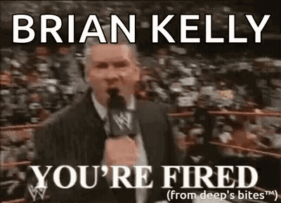 A Man In A Suit Is Talking Into A Microphone In Front Of A Crowd And Says `` You 'Re Fired '' . GIF