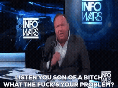 A Man In A Suit Is Talking Into A Microphone In Front Of A Sign That Says Info Wars GIF