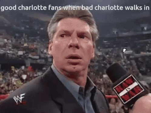 A Man In A Suit Is Talking Into A Microphone With The Words " Good Charlotte Fans When Bad Charlotte Walks In " Above Hi GIF