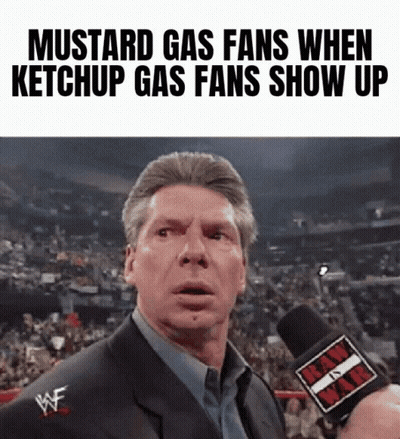 A Man In A Suit Is Talking Into A Microphone With The Words Mustard Gas Fans When Ketchup Gas Fans Show Up On The Bottom GIF