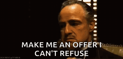 A Man In A Suit Is Talking On A Cell Phone And Saying Make Me An Offer I Can 'T Refuse . GIF