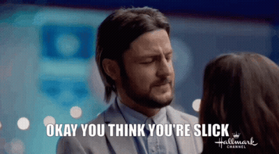 A Man In A Suit Is Talking To A Woman In A Hallmark Channel Ad . GIF