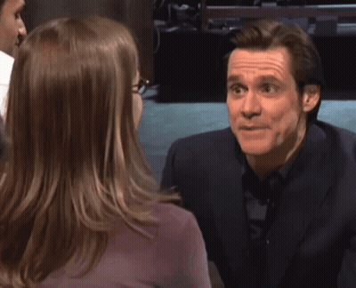 A Man In A Suit Is Talking To A Woman With The Words Money Money Written Above Him GIF