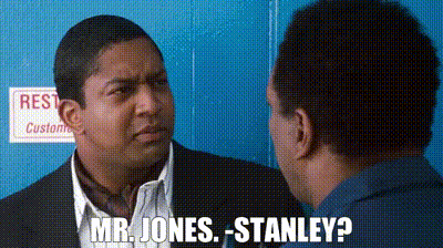 A Man In A Suit Is Talking To Another Man In A Blue Shirt And Says Mr. Jones Stanley . GIF