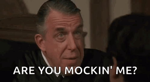 A Man In A Suit Is Talking To Another Man In A Courtroom And The Man Is Asking The Judge If He Is Mocking Him GIF