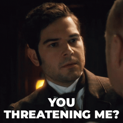A Man In A Suit Is Talking To Another Man With The Words You Threatening Me GIF